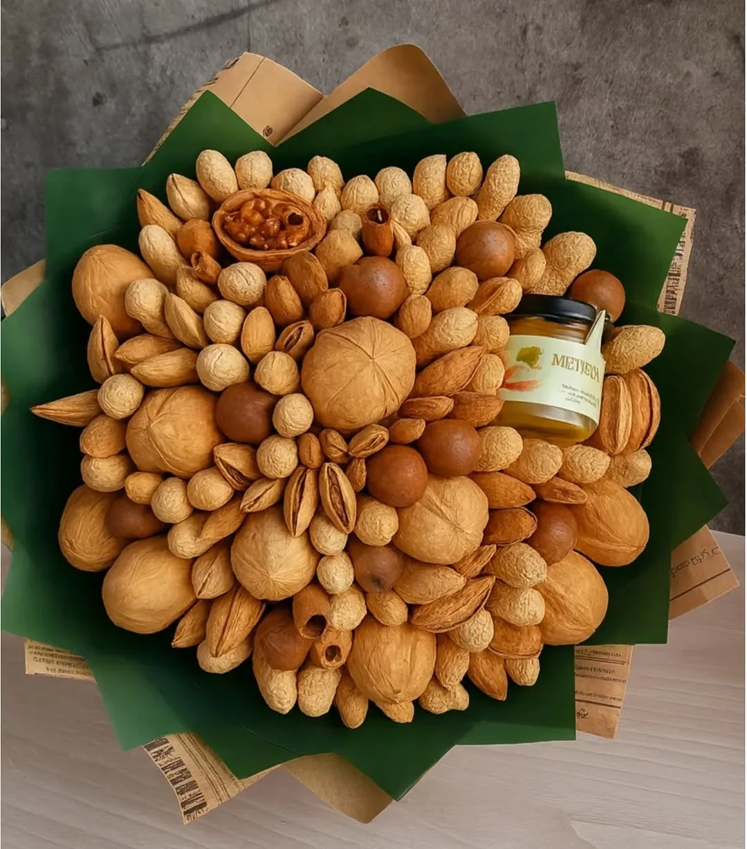 Handmade nut bouquet with honey jar and walnuts in green wrapping, creative gift for corporate clients in Abovyan.
