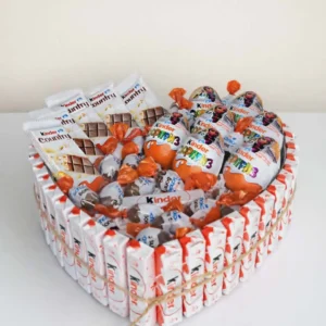A 25cm heart-shaped gift box filled with Kinder chocolate bars and Kinder Surprise eggs, tied with rustic twine, presented on a white surface.