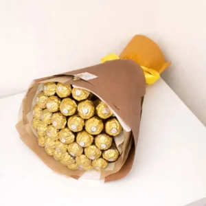 Premium bouquet made entirely of gold-wrapped Ferrero Rocher chocolates, styled in brown kraft paper with a bright yellow ribbon