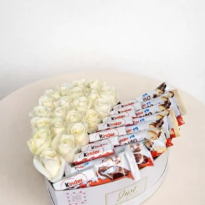 Large white heart-shaped gift box, half-filled with fresh white roses and half-filled with Kinder chocolate bars