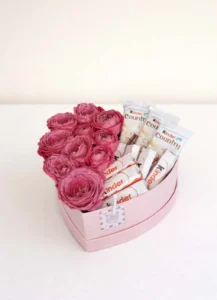 Luxury pink heart gift box arranged with fresh peony-shaped spray roses and genuine Kinder chocolate bars by BooqArt flower shop