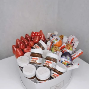 A 25cm white heart-shaped gift box filled with fresh red strawberries, mini Nutella jars, Kinder Surprise eggs, and Kinder chocolate bars.