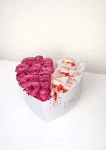 Luxury white heart-shaped gift box filled with fresh magenta peony roses and Raffaello chocolates by BooqArt